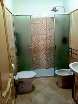 a bathroom with a shower and a toilet and a sink at La Casetta di Miriam a Piazza di Spagna in Rome