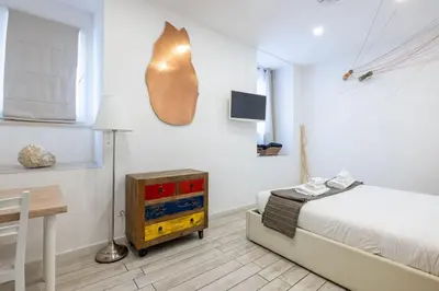 a bedroom with a bed and a table and a desk at Vatican Momahouse Luxury by Varental in Rome