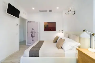 a white bedroom with a bed and a desk at Vatican Momahouse Luxury by Varental in Rome