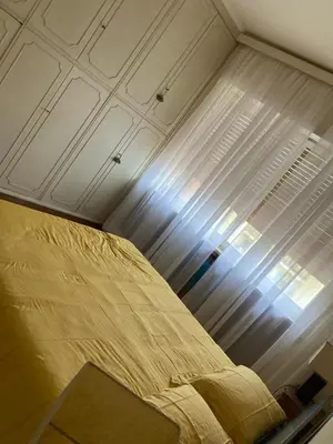 a bed in a room with a ceiling and a window at Le Mille e Una Notte in Rome