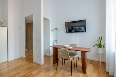 a dining room with a table and a tv on a wall at Venere in Trevi in Rome