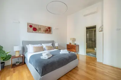 a bedroom with a large bed and a wooden floor at Venere in Trevi in Rome