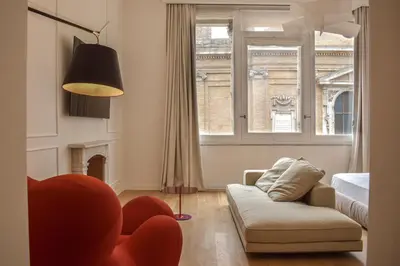 a living room with a couch and a window at Youroom Margutta in Rome