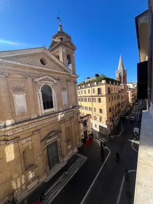 an old building with a clock tower on a street at Youroom Margutta in Rome