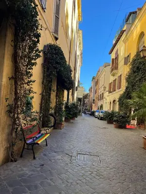 a bench sitting on a street next to a building at Youroom Margutta in Rome