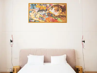 a bedroom with a painting above a bed at Youroom Margutta in Rome