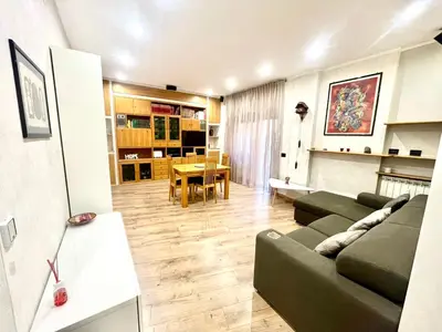 a living room with a couch and a dining room at 15 Min. Colosseo 2 - Casa di Micca in Rome