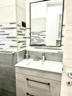 a bathroom with a sink and a mirror at 15 Min. Colosseo 2 - Casa di Micca in Rome