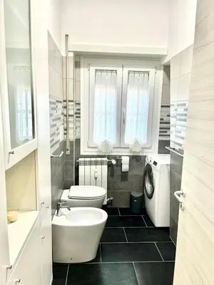 a white bathroom with a sink and a toilet at 15 Min. Colosseo 2 - Casa di Micca in Rome