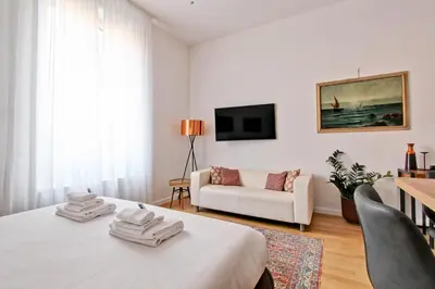 a white room with a bed and a couch at Giove in Trevi in Rome