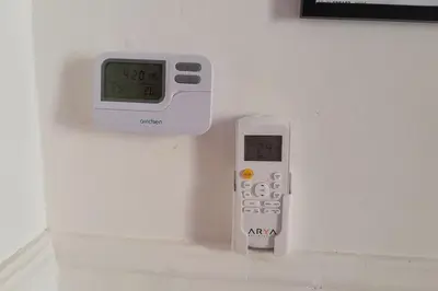a clock on a wall next to a remote control at Pigneto Easy Stay in Rome