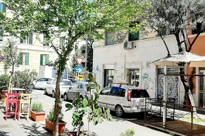 a group of cars parked on a city street at Pigneto Easy Stay in Rome