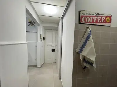 a bathroom with a coffee sign on the wall at Pigneto Easy Stay in Rome