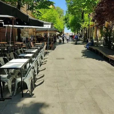 a row of tables and chairs on a sidewalk at Pigneto Easy Stay in Rome