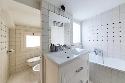 a white bathroom with a sink and a toilet at iFlat Shabby Chic Apartament in Rome