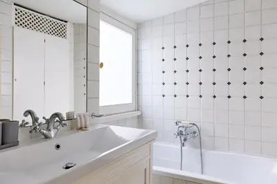 a white bathroom with a sink and a mirror at iFlat Shabby Chic Apartament in Rome