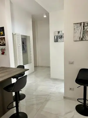 a room with chairs and paintings on the walls at Urban Chic San Paolo Apartment Rome in Rome