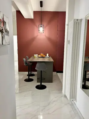 a dining room with a table and chairs at Urban Chic San Paolo Apartment Rome in Rome