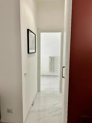 a hallway with a door leading into a room at Urban Chic San Paolo Apartment Rome in Rome