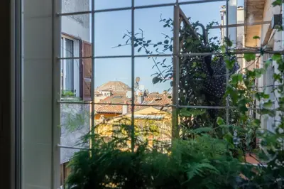 a view of the city seen through a window at iFlat Bright and Modern Flat near the Pantheon in Rome