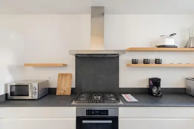 a kitchen with a stove top oven next to a microwave at iFlat Bright and Modern Flat near the Pantheon in Rome