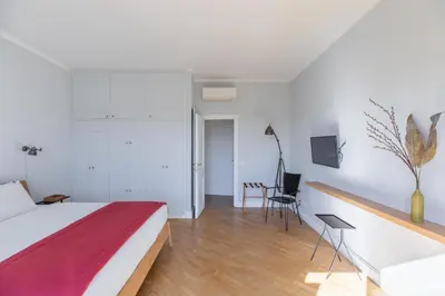 a bedroom with a bed and a desk and a tv at iFlat Bright and Modern Flat near the Pantheon in Rome