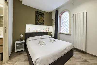 a bedroom with a large bed and a window at iFlat One step from Colosseum in Rome
