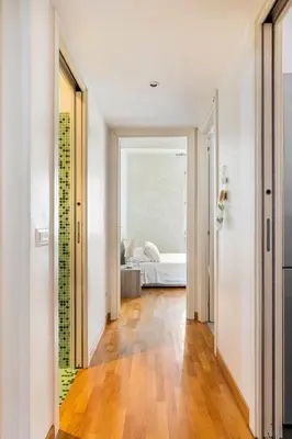 a hallway leading to a bedroom with a bed at Comfortable apartment Via Appia - B in Rome