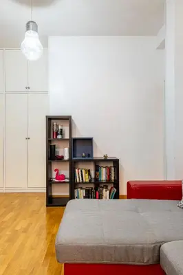 a living room with a bed and a book shelf at Comfortable apartment Via Appia - B in Rome