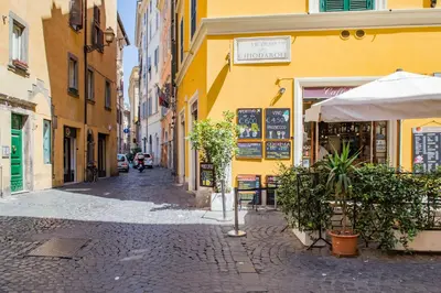 a cobblestone street in a city with a yellow building at Campo De Fiori- Deluxe&Relax in Rome
