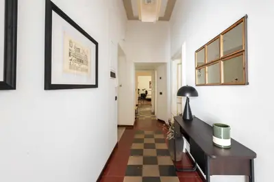 a hallway with a table and a checkered floor at Maison Leo a S. Maria Maggiore in Rome