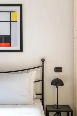 a bedroom with a bed and a lamp on a table at Maison Leo a S. Maria Maggiore in Rome