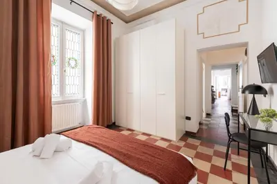 a bedroom with a bed and a desk in a room at Maison Leo a S. Maria Maggiore in Rome