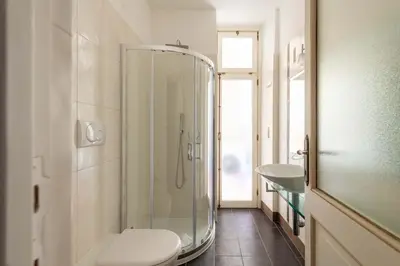 a bathroom with a shower and a toilet and a sink at Maison Leo a S. Maria Maggiore in Rome