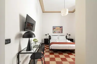 a bedroom with a bed and a glass table at Maison Leo a S. Maria Maggiore in Rome
