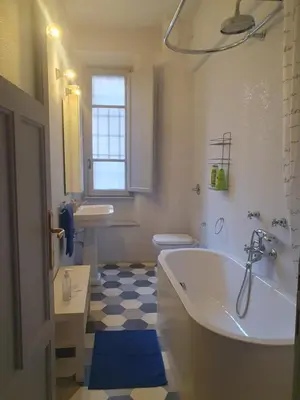 a bathroom with a tub and a toilet and a sink at House Cocò in Rome