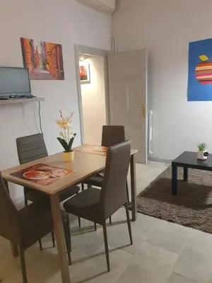 a dining room with a wooden table and chairs at House Cocò in Rome