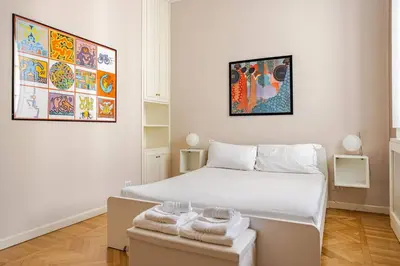 a bedroom with a bed and a table with towels on it at Lilla’s Apartment in Rome