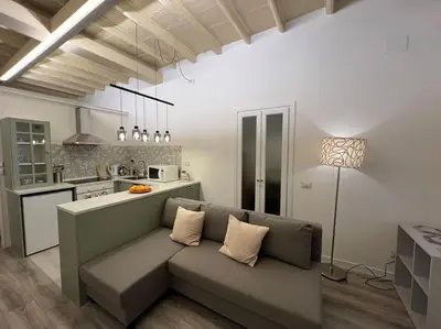 a living room with a couch and a kitchen at Beloved Trastevere in Rome