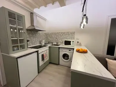 a kitchen with a sink and a washing machine at Beloved Trastevere in Rome