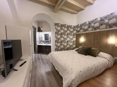 a bedroom with a bed and a flat screen tv at Beloved Trastevere in Rome