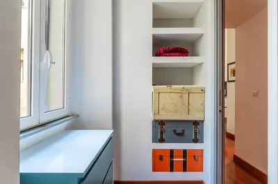 a room with a window and a shelf with a box at GuestHost - San Giovanni in Laterano Dazzling Apartment in Rome