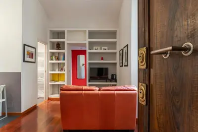 a living room with a couch and a book shelf at GuestHost - San Giovanni in Laterano Dazzling Apartment in Rome