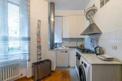 a kitchen with a sink and a stove top oven at Domus Villa Scipioni in Rome