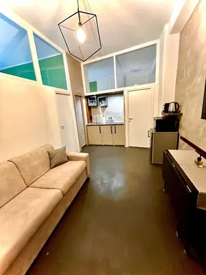 a living room with a couch and a table at JEF Apartments San Giovanni by Hostand in Rome