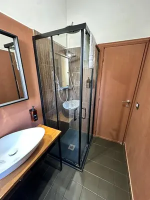 a bathroom with a shower and a sink at JEF Apartments San Giovanni by Hostand in Rome
