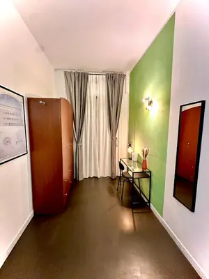 a hallway with a door and a table and a window at JEF Apartments San Giovanni by Hostand in Rome