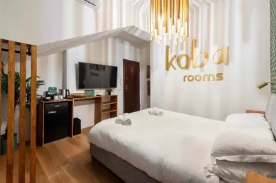 a hotel room with a bed and a tv at Koba Rooms Nomentano in Rome
