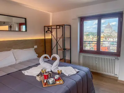 a bedroom with a bed with a tray of food on it at San Peter View in Rome
