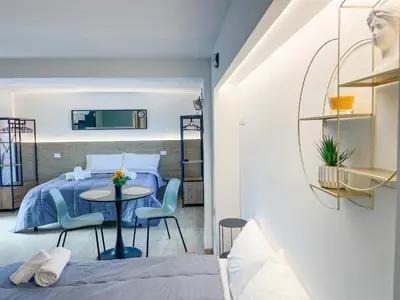 a bedroom with a bed and a table and chairs at San Peter View in Rome